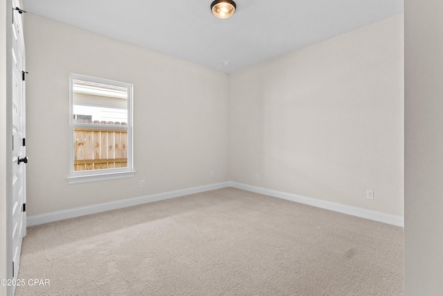 spare room with light colored carpet