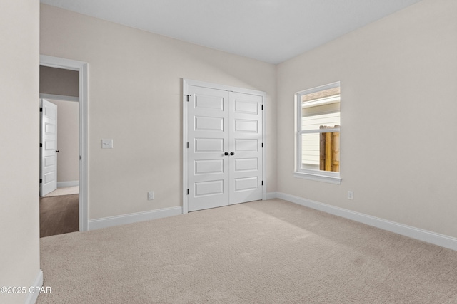 unfurnished bedroom with a closet and carpet flooring