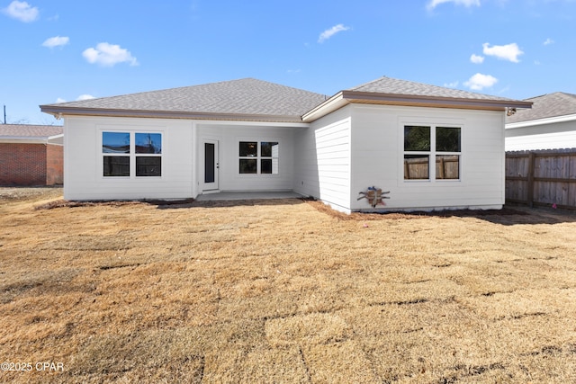 view of front of home with a front yard and a patio