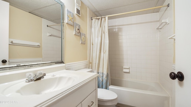 full bathroom featuring vanity, shower / bath combination with curtain, and toilet