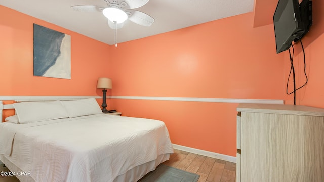 bedroom with light hardwood / wood-style flooring and ceiling fan