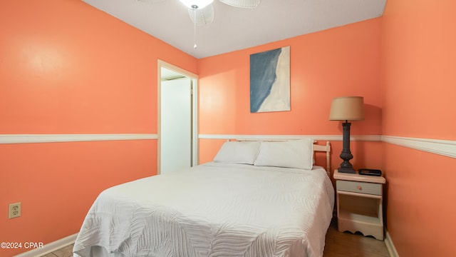 bedroom with ceiling fan and hardwood / wood-style floors