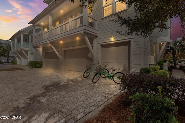 view of front facade featuring a balcony and a garage