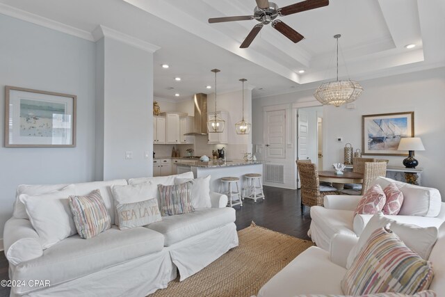 dining space featuring french doors, ceiling fan with notable chandelier, a tray ceiling, sink, and dark hardwood / wood-style floors