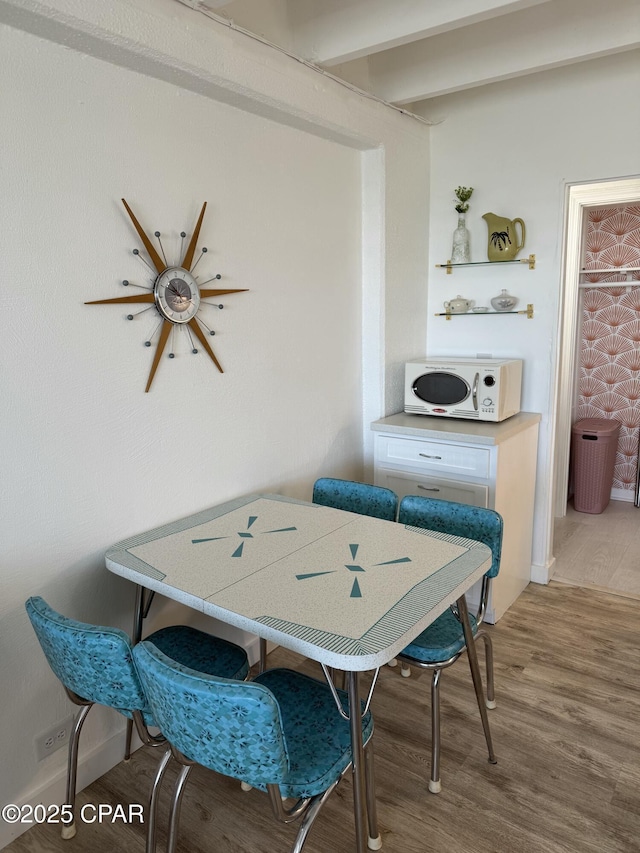 dining space with hardwood / wood-style flooring