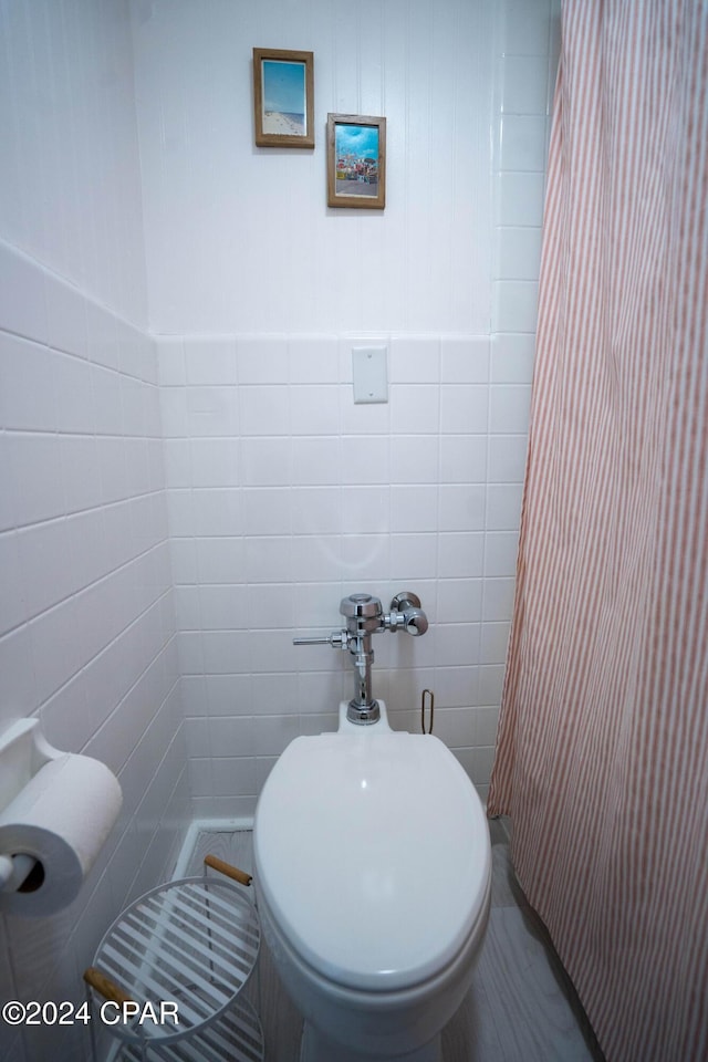 bathroom with tile walls