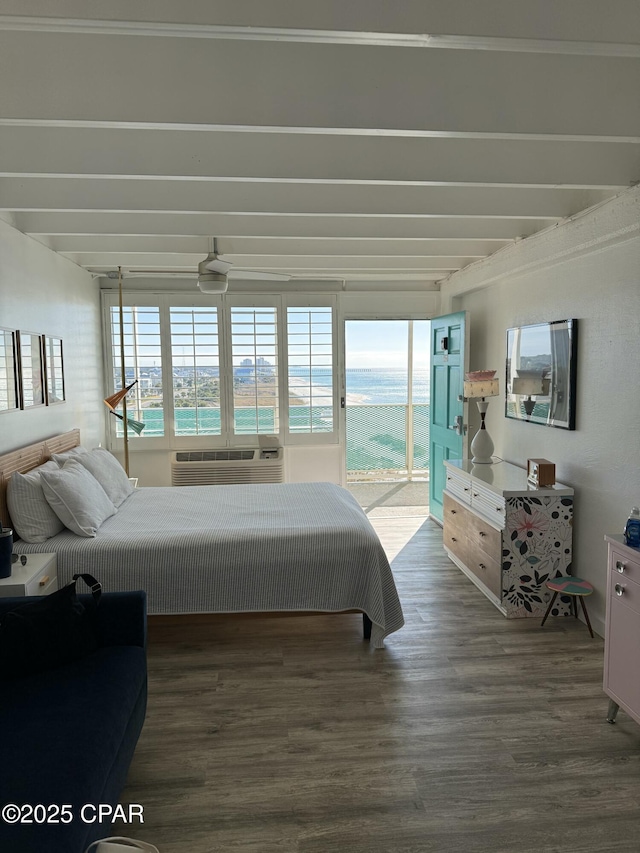 bedroom with dark hardwood / wood-style floors, access to exterior, and an AC wall unit