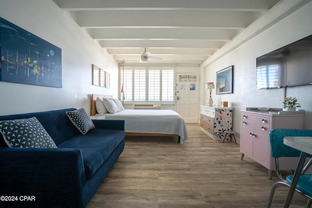 bedroom with beamed ceiling and wood-type flooring