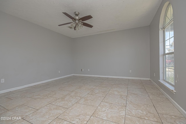 spare room with a textured ceiling and ceiling fan