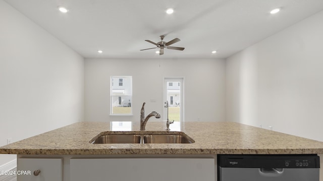 kitchen with dishwasher, an island with sink, ceiling fan, and sink