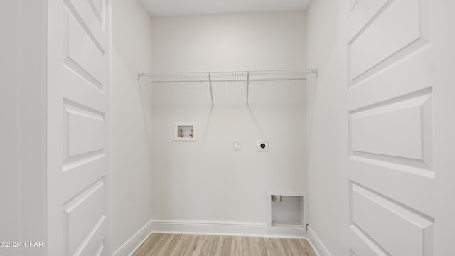 laundry area featuring hookup for an electric dryer, light hardwood / wood-style flooring, and washer hookup