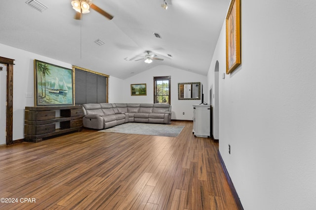 living room with hardwood / wood-style flooring, ceiling fan, and vaulted ceiling