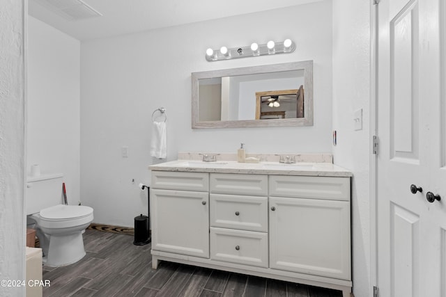 bathroom featuring hardwood / wood-style floors, vanity, and toilet