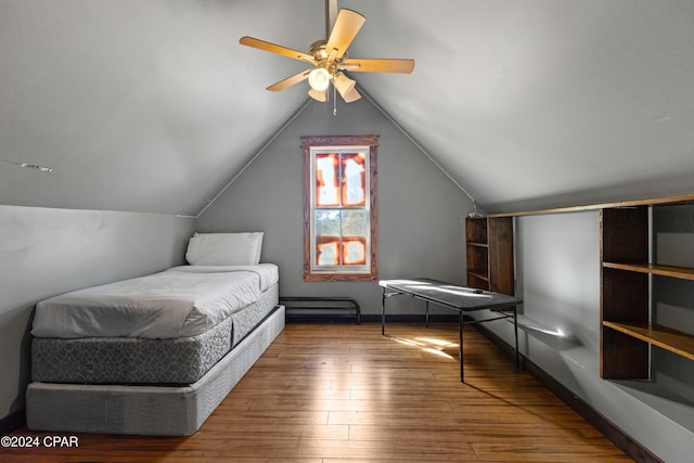 bedroom with hardwood / wood-style floors, ceiling fan, and lofted ceiling