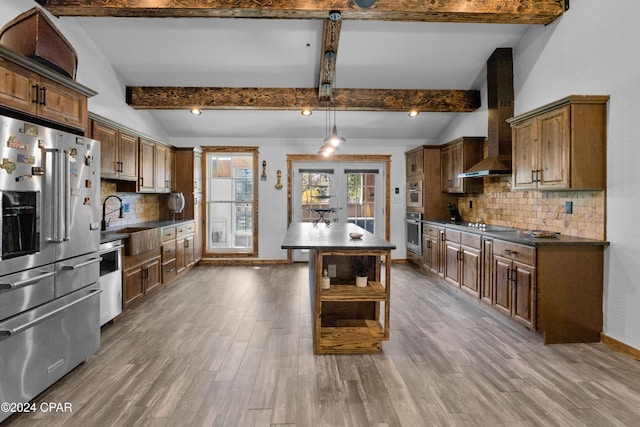 kitchen featuring pendant lighting, a kitchen island, appliances with stainless steel finishes, and tasteful backsplash