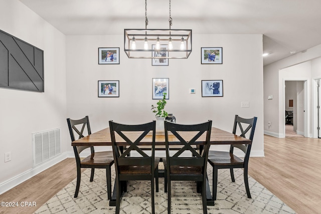 dining space featuring a chandelier and light hardwood / wood-style flooring