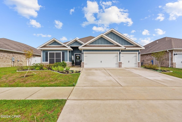 craftsman house with a front yard and a garage