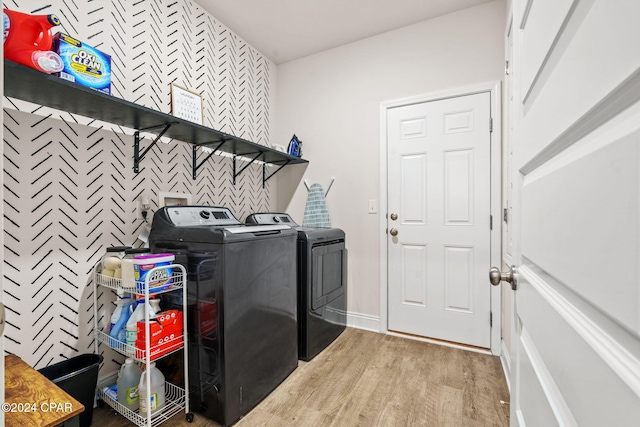 washroom with separate washer and dryer and light wood-type flooring