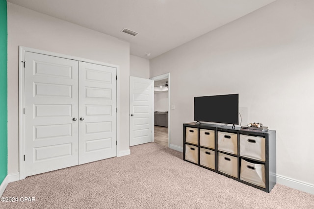 carpeted bedroom with a closet