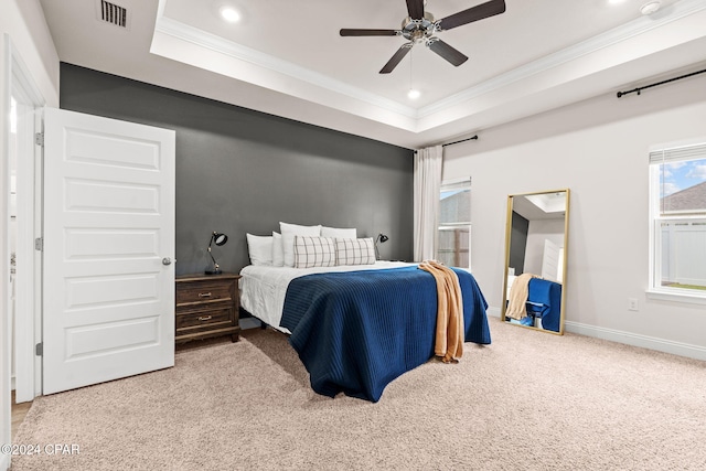 bedroom featuring a raised ceiling, ceiling fan, crown molding, and light colored carpet