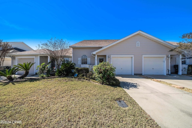 ranch-style home with a garage and a front lawn