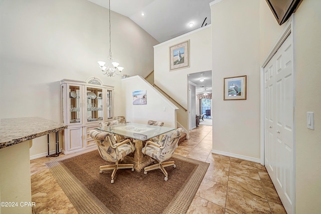 dining area with light tile patterned floors, an inviting chandelier, and high vaulted ceiling