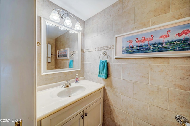 bathroom featuring vanity and tile walls