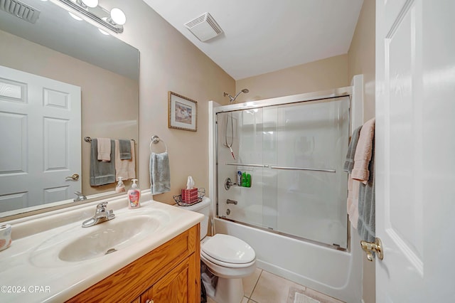 full bathroom with toilet, tile patterned flooring, vanity, and combined bath / shower with glass door