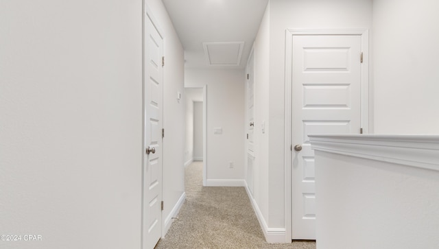 hall with light colored carpet