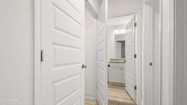 hallway with light hardwood / wood-style flooring