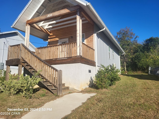 view of side of home with a yard