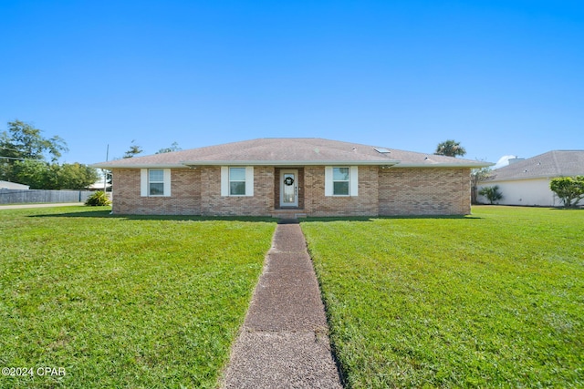 single story home featuring a front lawn