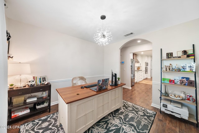 office space with dark hardwood / wood-style flooring and a notable chandelier