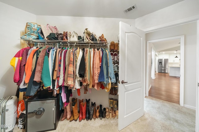 spacious closet with carpet flooring and lofted ceiling