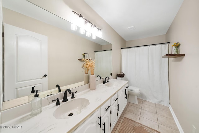 bathroom featuring tile patterned flooring, vanity, and toilet