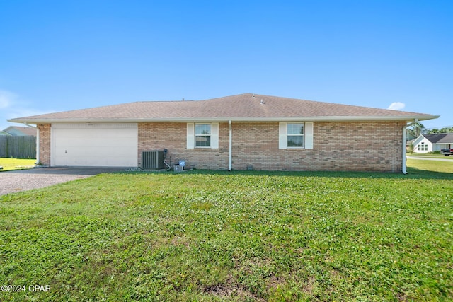 exterior space with a garage, central air condition unit, and a front yard