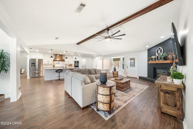 living room featuring a fireplace, ceiling fan, dark wood-type flooring, and lofted ceiling with beams