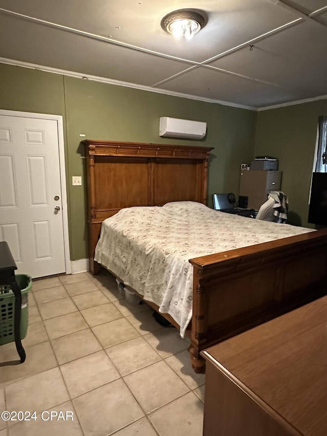 bedroom featuring an AC wall unit, crown molding, and light tile patterned floors