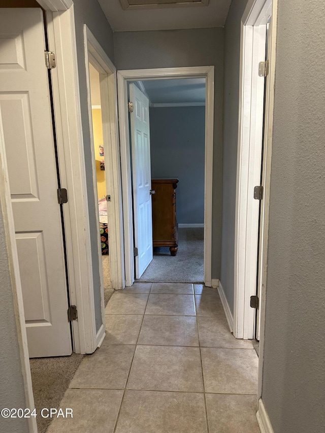 corridor featuring light tile patterned floors