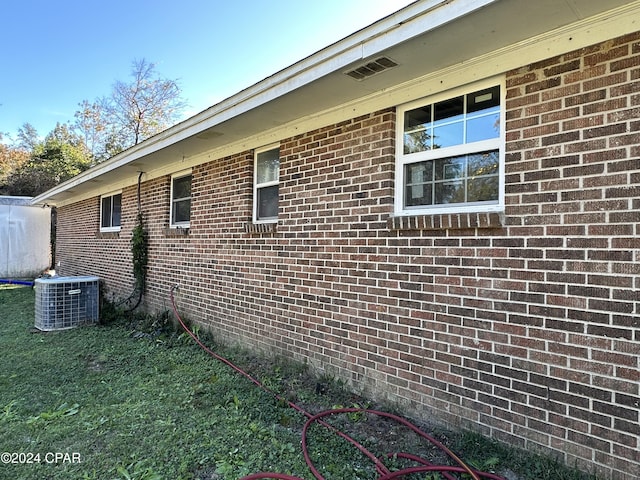 view of side of home with central AC unit