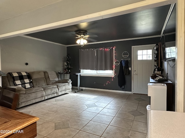 tiled living room featuring ceiling fan and ornamental molding