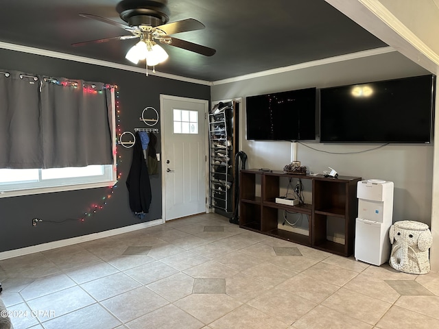 foyer entrance featuring a wealth of natural light, crown molding, ceiling fan, and light tile patterned floors