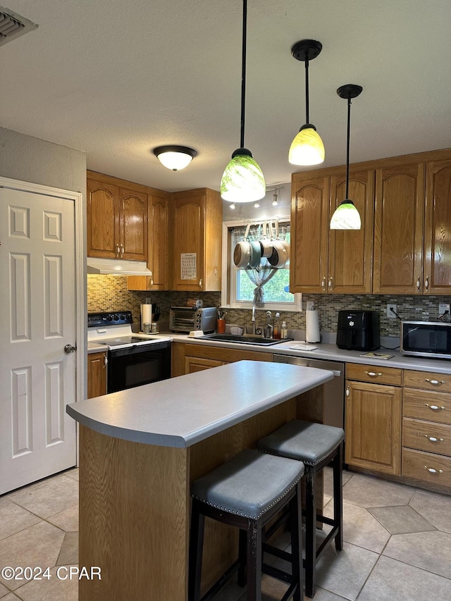 kitchen featuring electric range, sink, light tile patterned floors, and pendant lighting