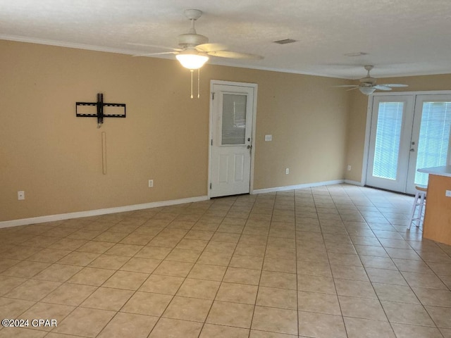 spare room with ceiling fan, light tile patterned flooring, ornamental molding, and french doors