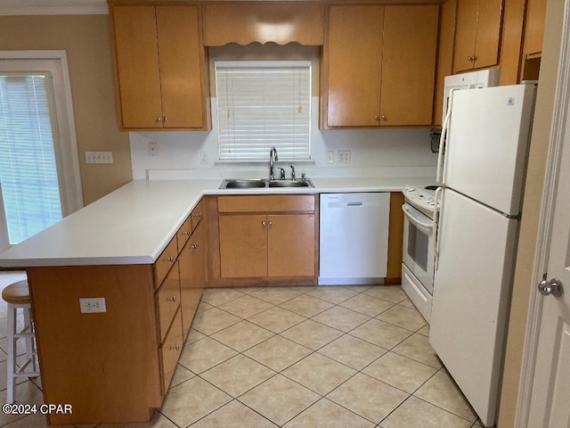 kitchen with kitchen peninsula, a breakfast bar, white appliances, sink, and light tile patterned floors