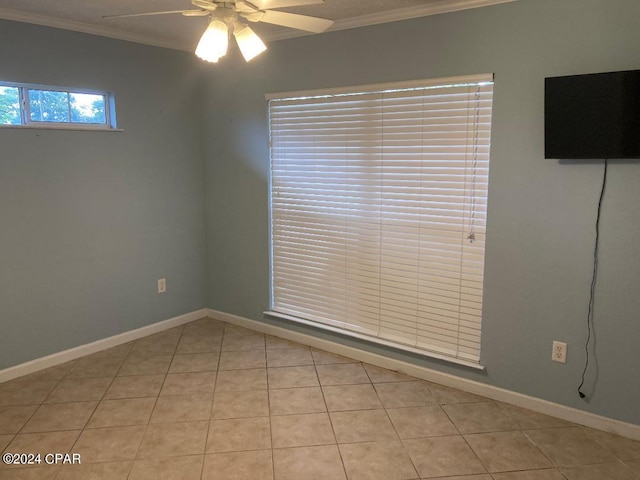 tiled spare room featuring crown molding and ceiling fan