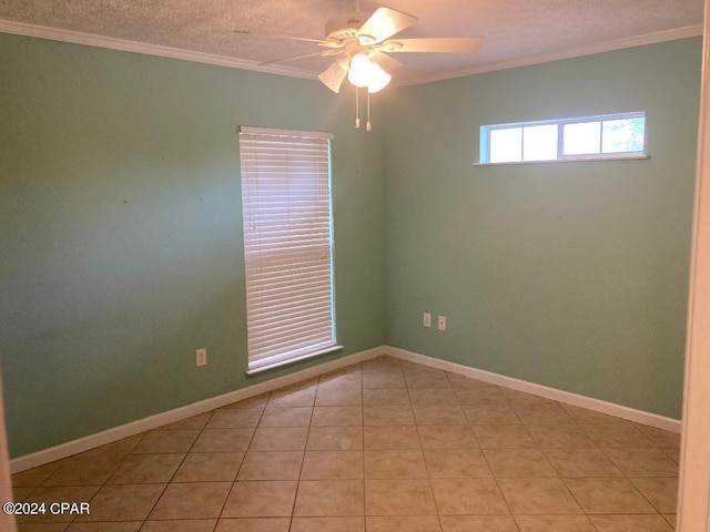 tiled empty room with ceiling fan, crown molding, and a textured ceiling