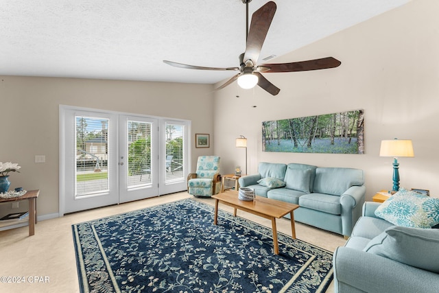 carpeted living room featuring ceiling fan, french doors, a textured ceiling, and vaulted ceiling