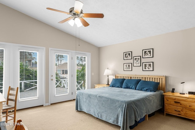 carpeted bedroom with a textured ceiling, access to outside, vaulted ceiling, and ceiling fan