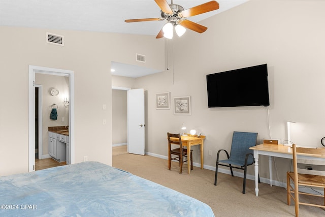 carpeted bedroom with ceiling fan, lofted ceiling, and ensuite bathroom